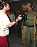 Photographer showing photograph to police, Delhi, India