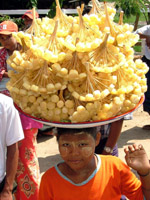 Young girl selling food from her head, Myanmar