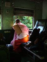 A nun looks out of a train window, Myanmar