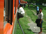 Man jumps onto a moving train, Myanmar
